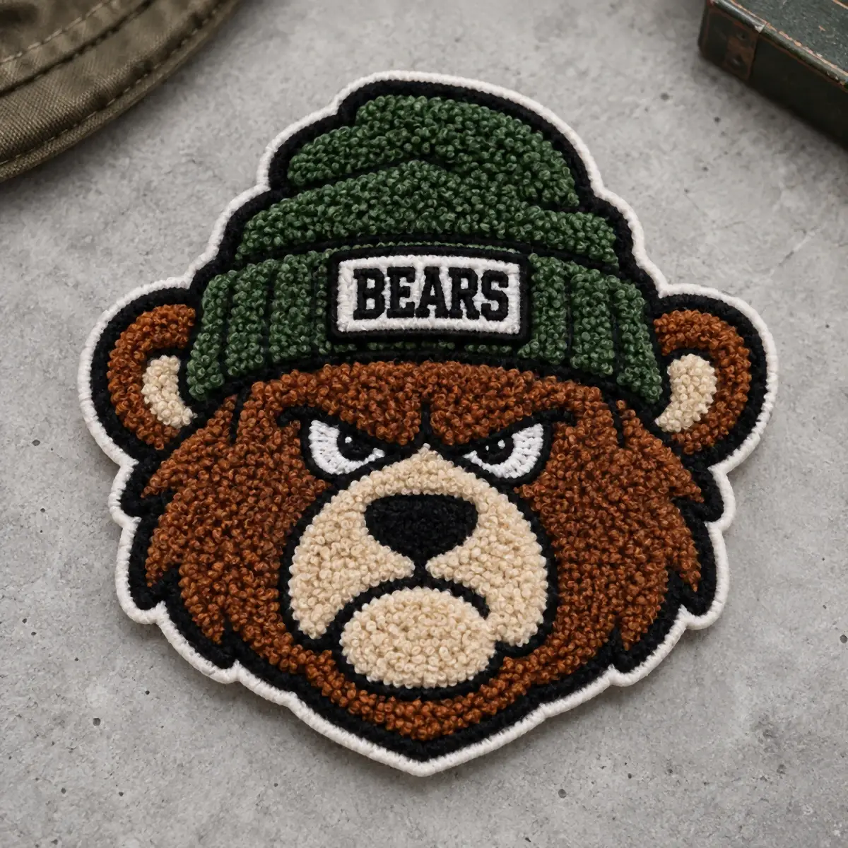 Chenille bear mascot patch wearing a green Bears beanie.