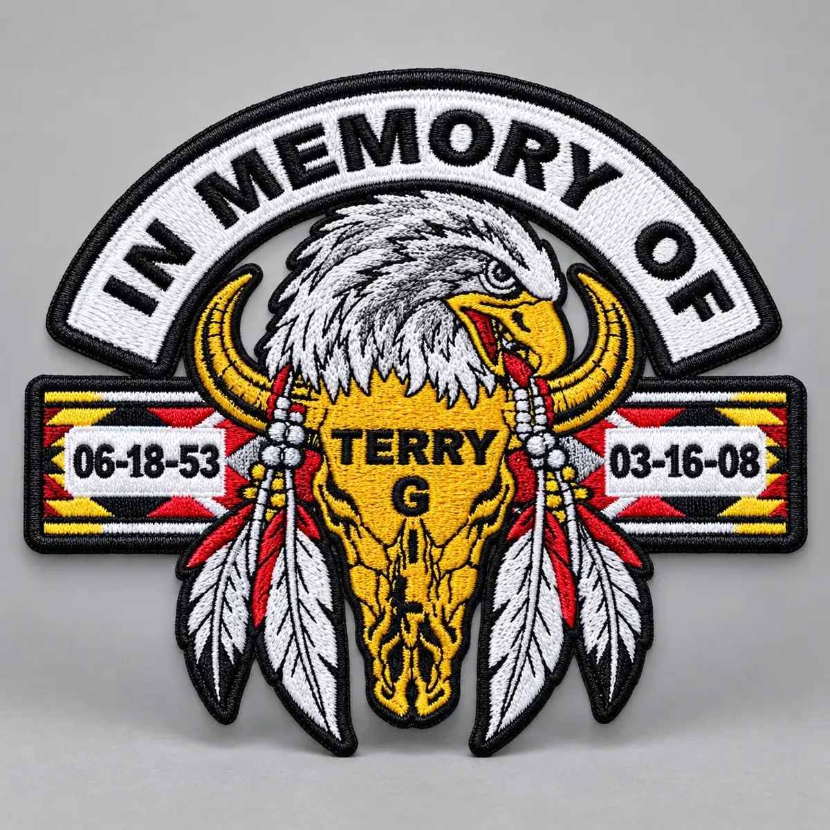 Embroidered In Memory Of patch with an eagle, feathers and a buffalo skull, dated 06-18-53 to 03-16-08.