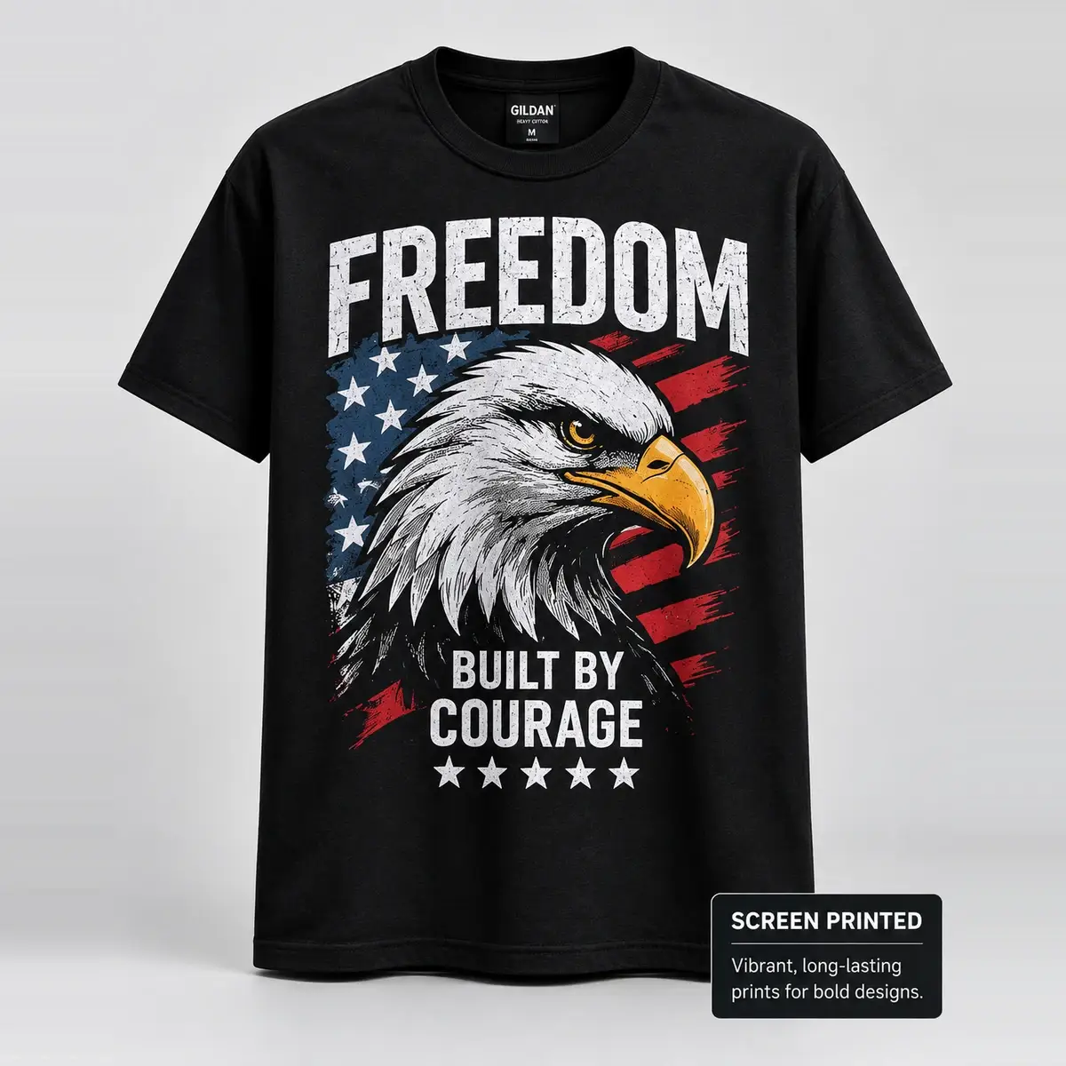 Black tee screen printed with a bald eagle over a US flag reading Freedom Built By Courage.