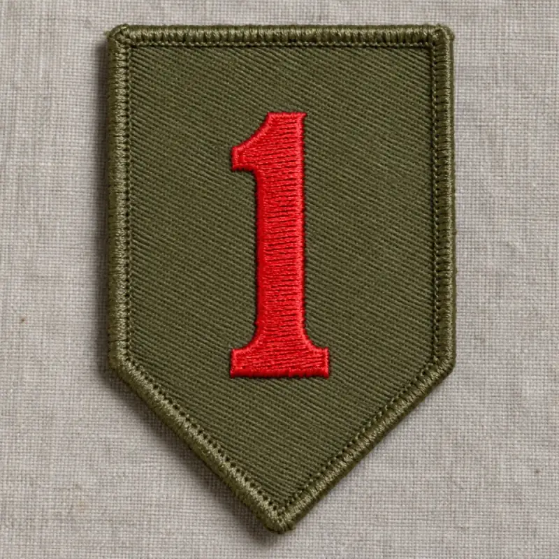 Olive embroidered shield patch with a red numeral one on linen.