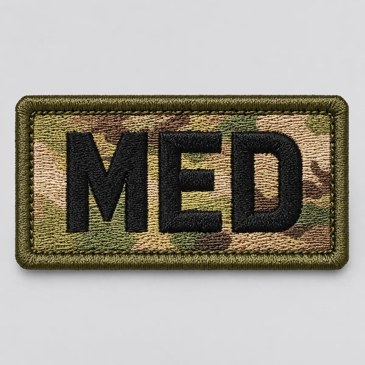OCP camouflage MED patch in black embroidered letters.