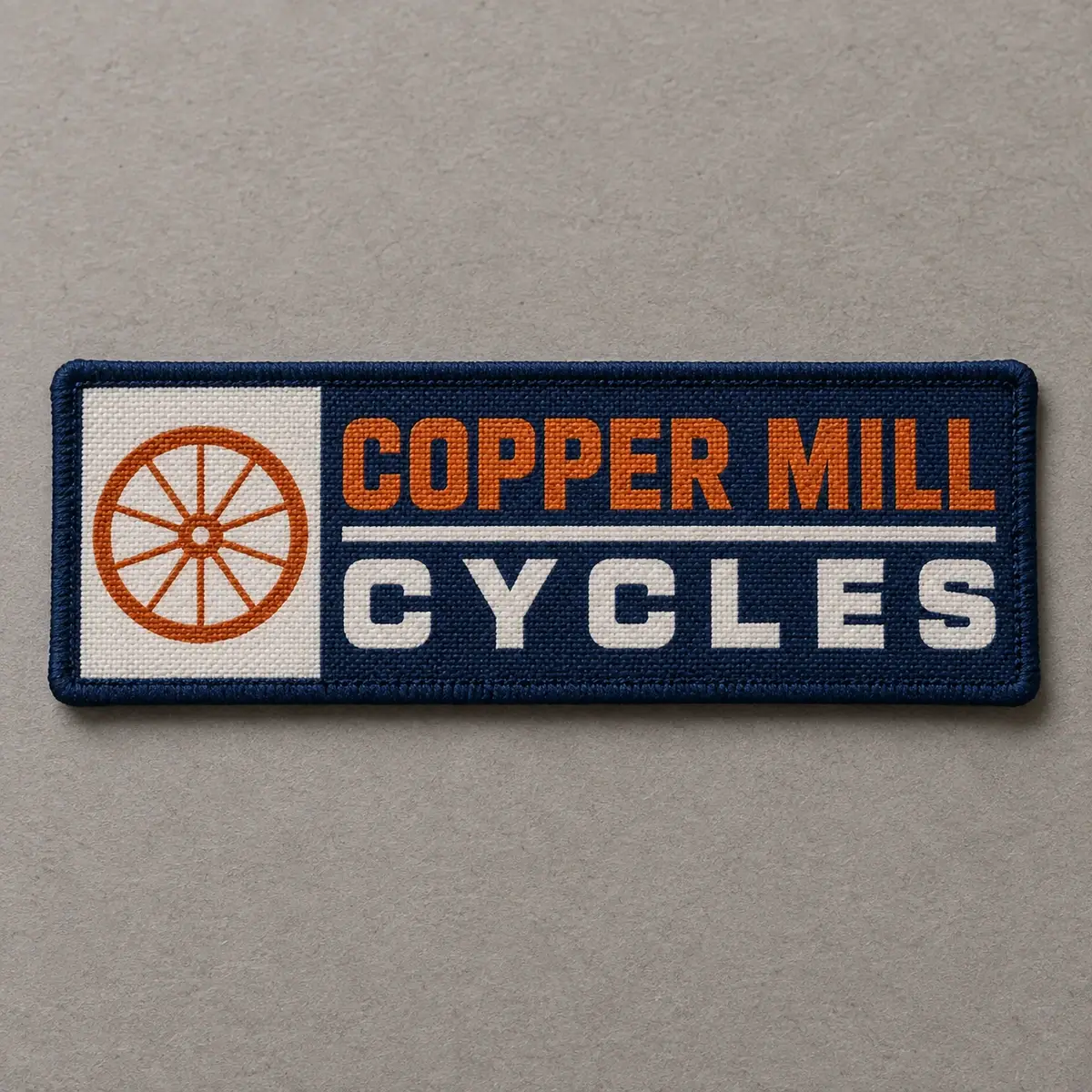 Printed Copper Mill Cycles patch with an orange wheel.