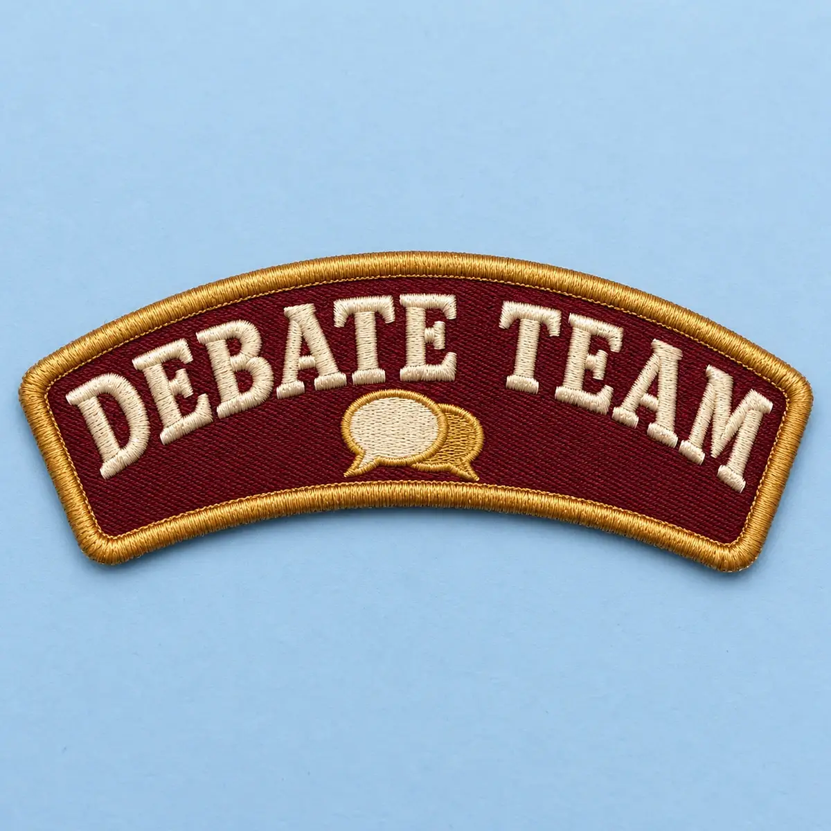 Maroon embroidered Debate Team rocker patch with speech bubbles.