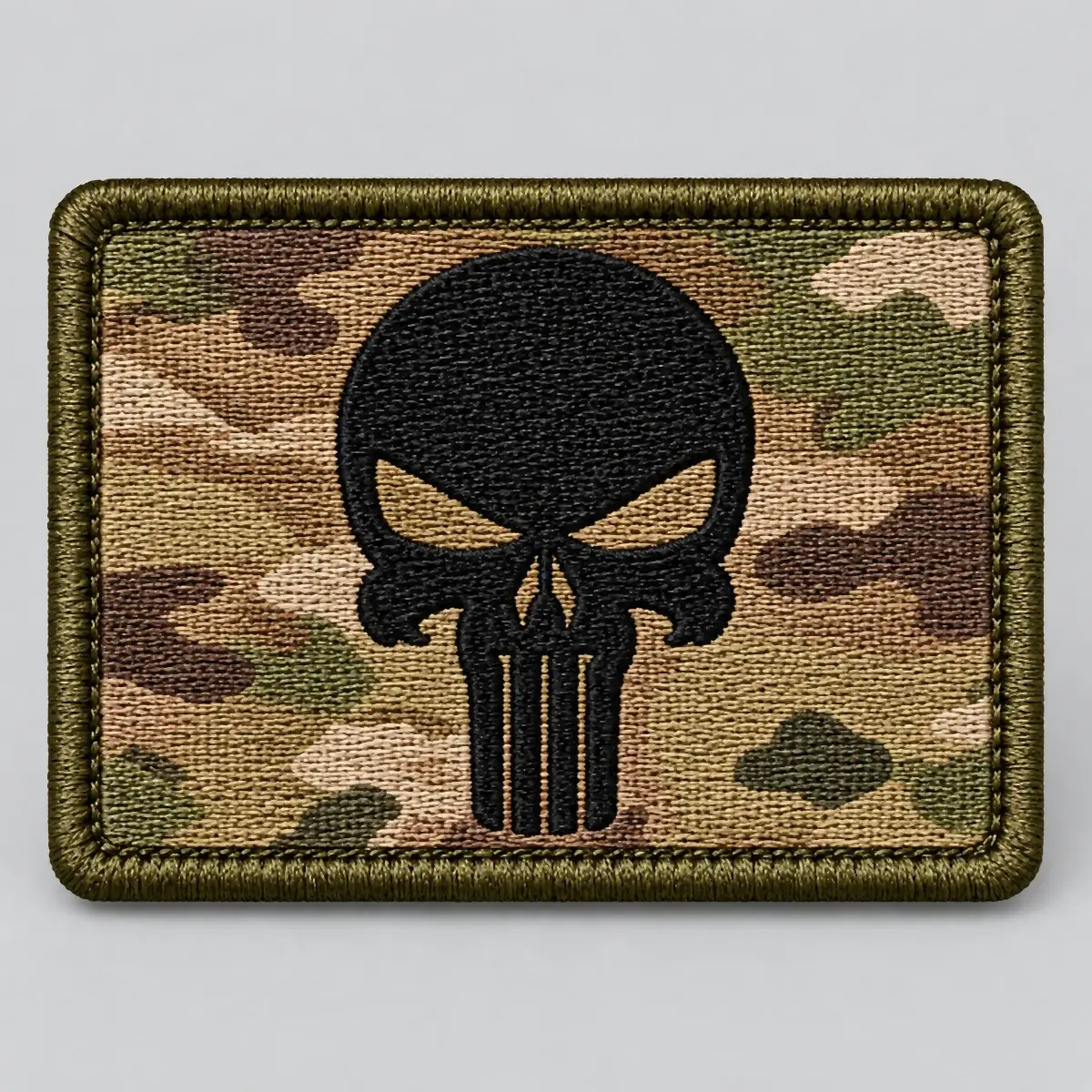 OCP camouflage patch with a black embroidered skull.