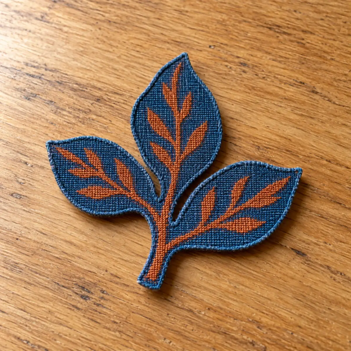 Printed leaf patch in orange and blue.