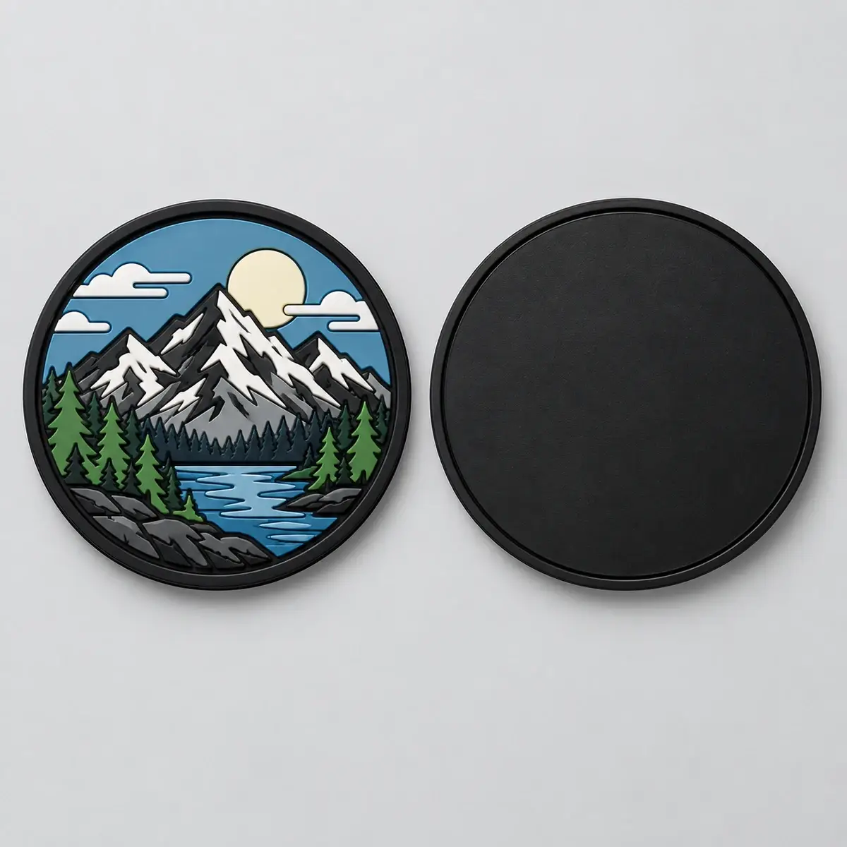 Round PVC mountain patch beside its smooth black PVC back.