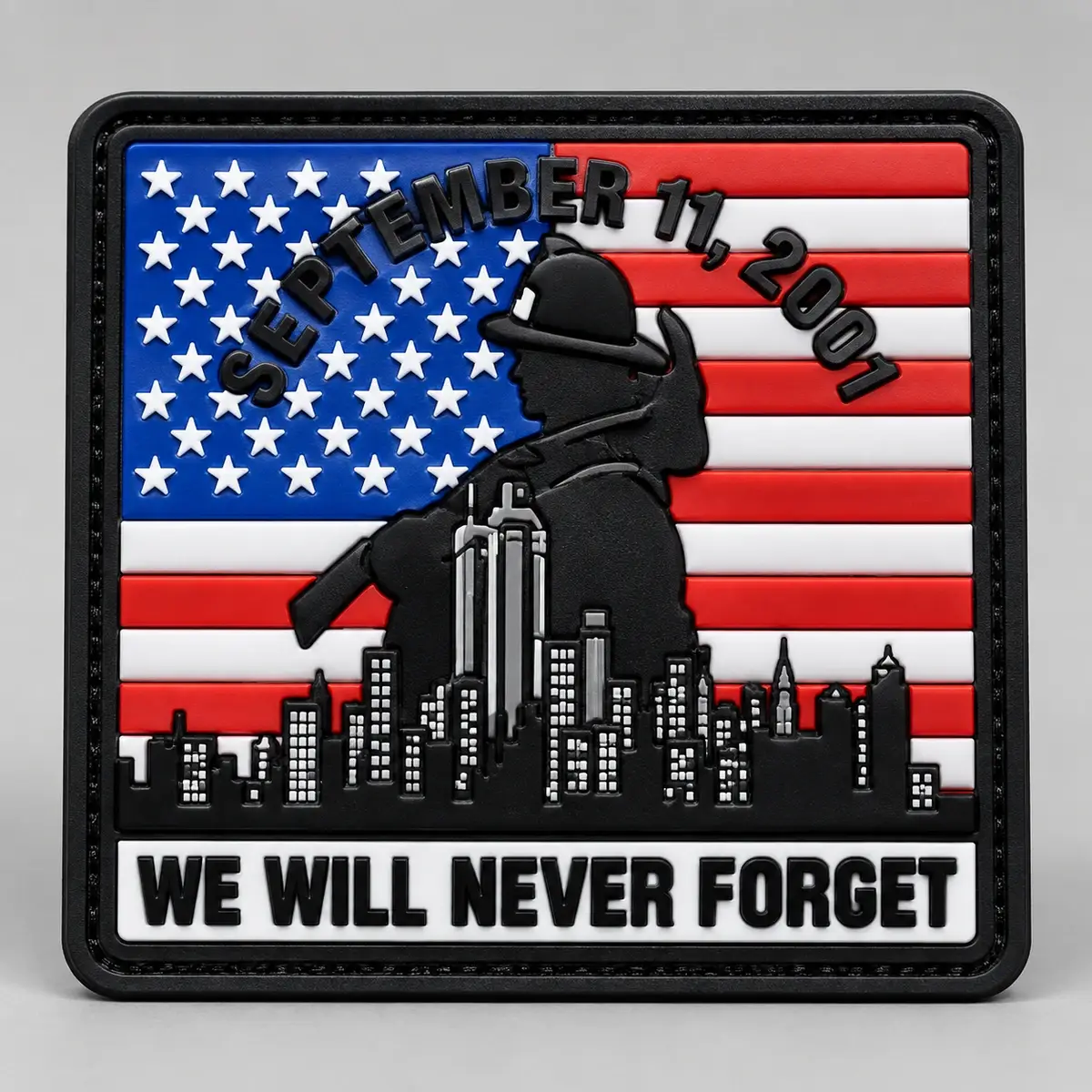 PVC September 11, 2001 We Will Never Forget patch with a firefighter silhouette over a US flag.