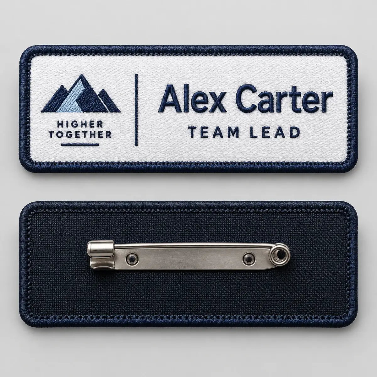 Embroidered Alex Carter Team Lead name badge above its back with a brooch pin.