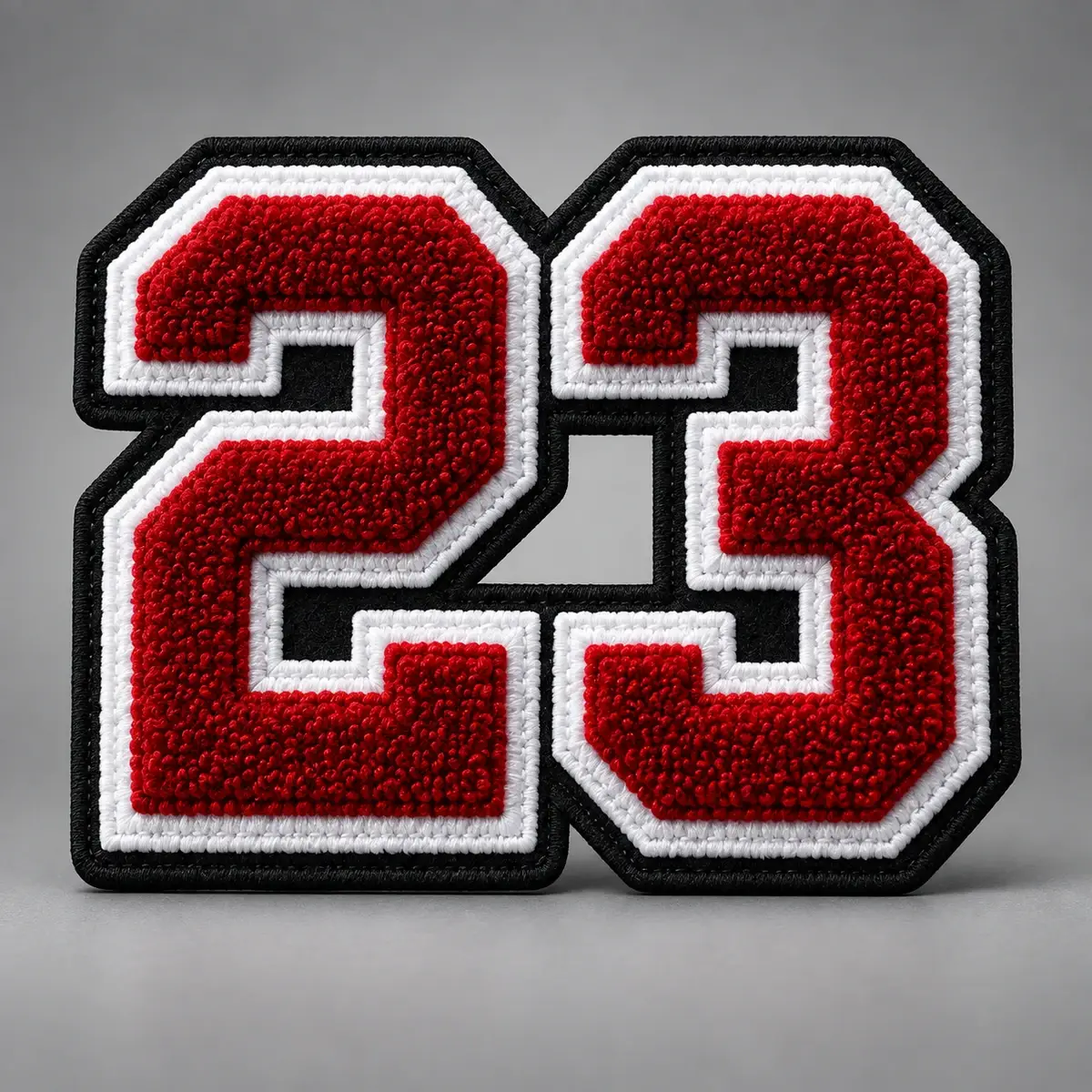 Red chenille number 23 with white and black tackle twill borders.
