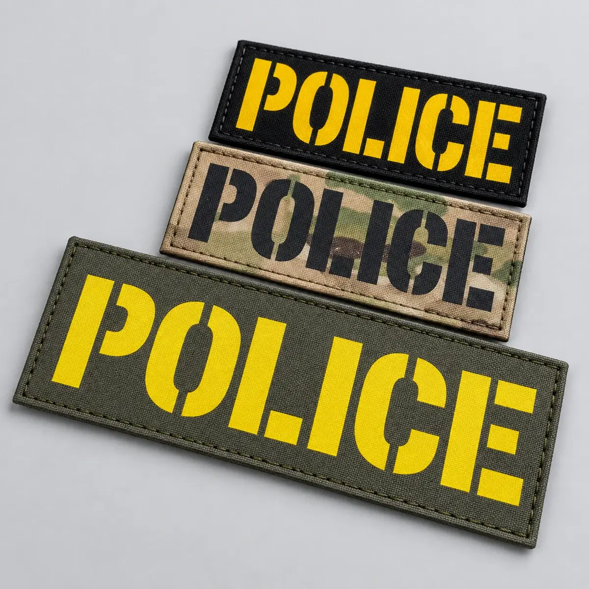 Three printed POLICE ID panels in yellow on black, multicam and olive.