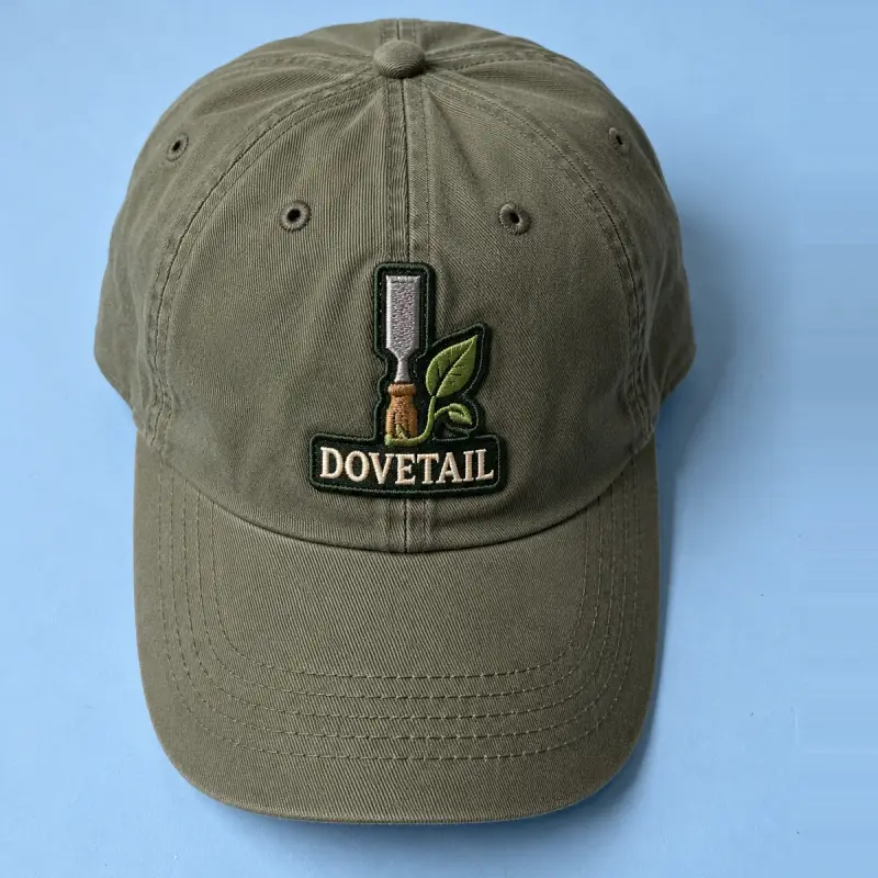 Embroidered Dovetail chisel and leaf patch on an olive cap.