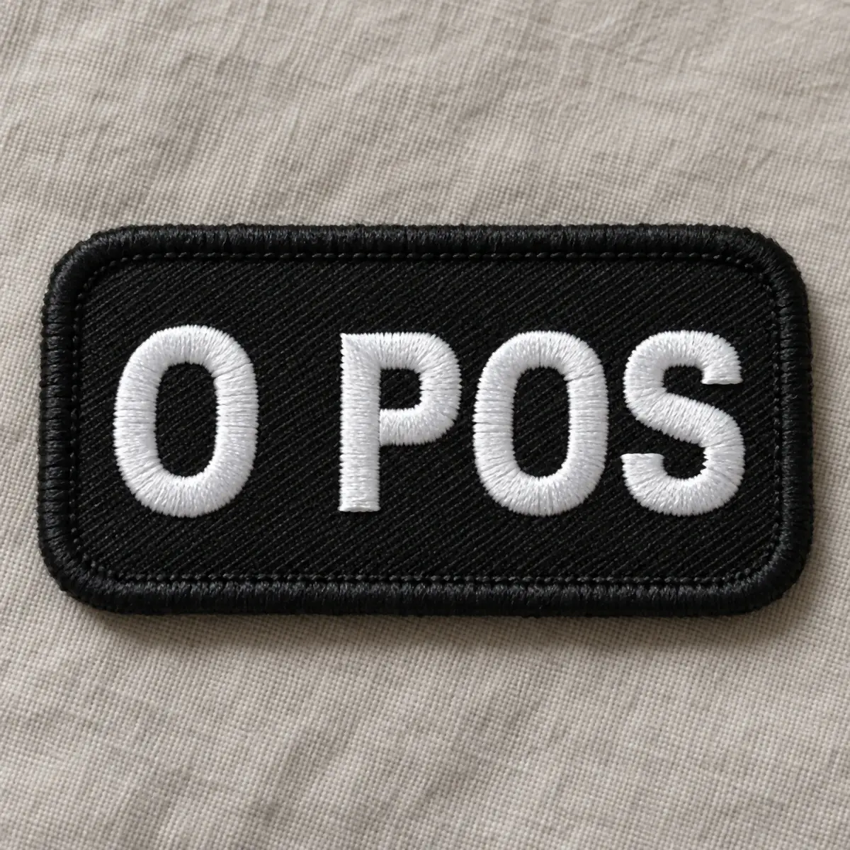 Black embroidered O POS blood type patch.