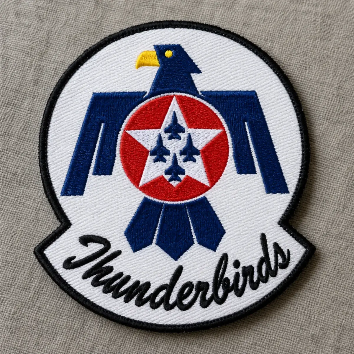 Embroidered Thunderbirds patch with a navy and white eagle around a red star of four jets.