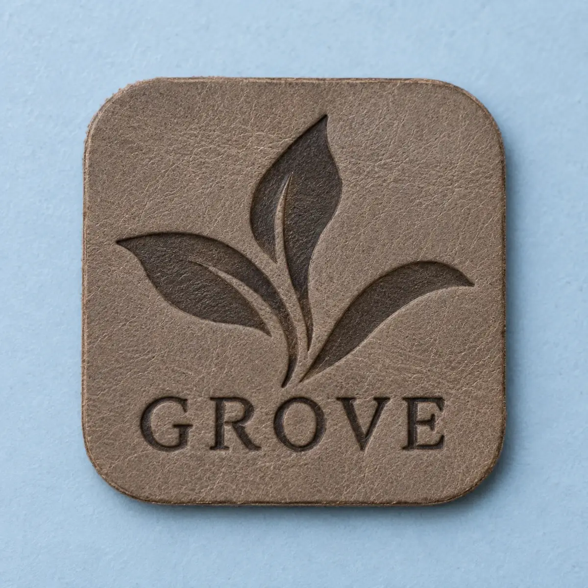 Grey Grove leather patch debossed with a leaf.