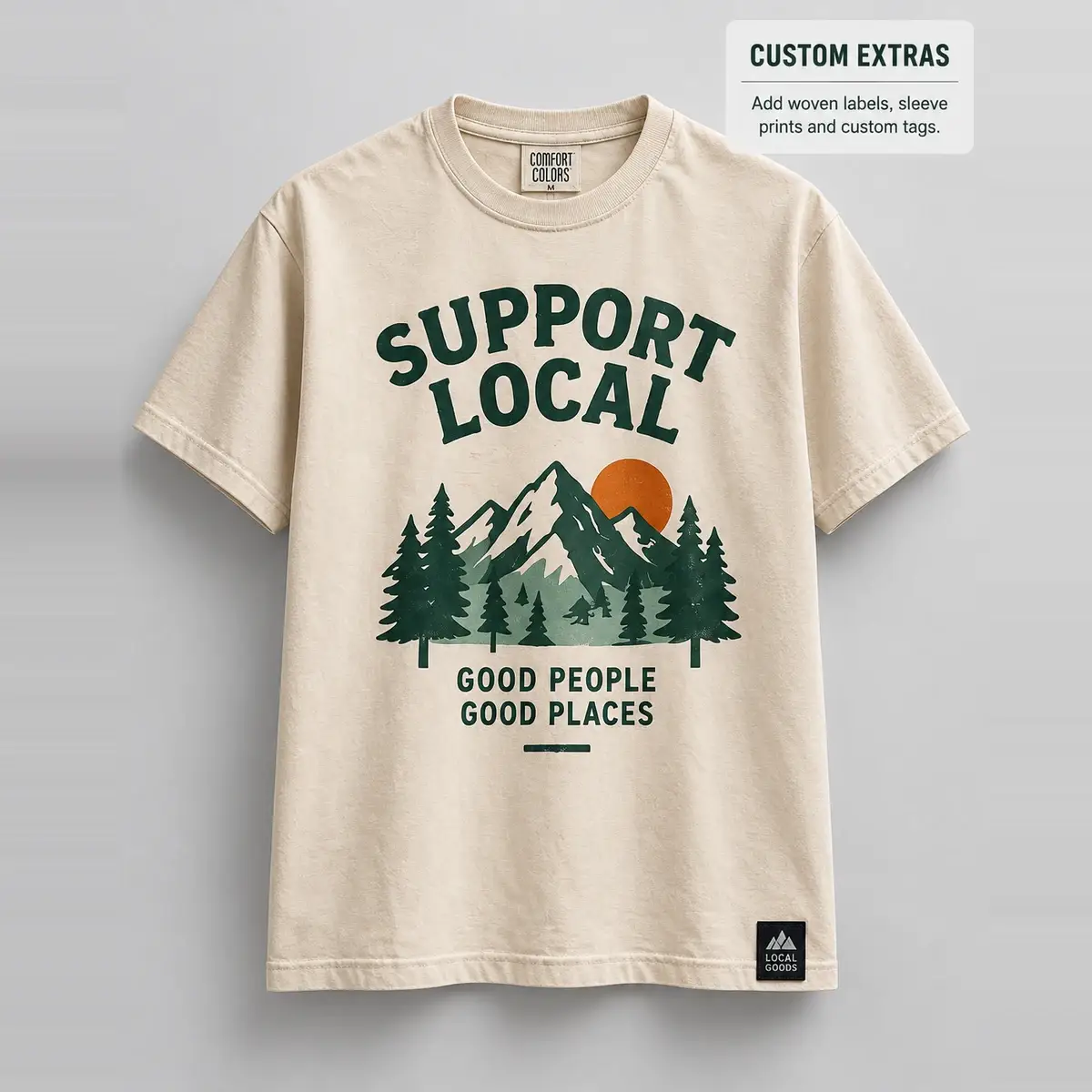 Cream tee printed with a green Support Local mountain design.