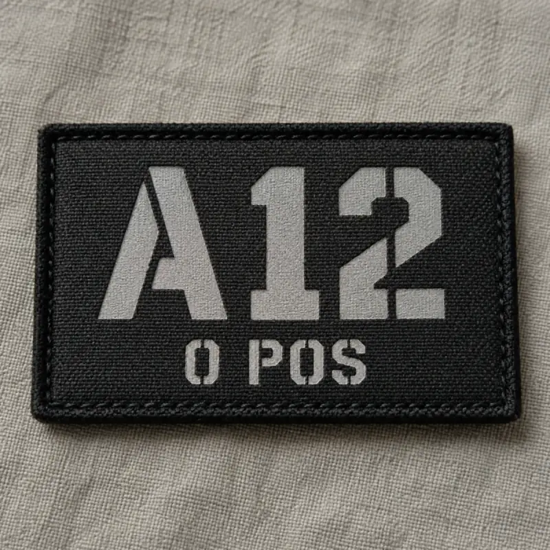 Black printed tactical patch reading A12 O POS in gray stencil lettering.